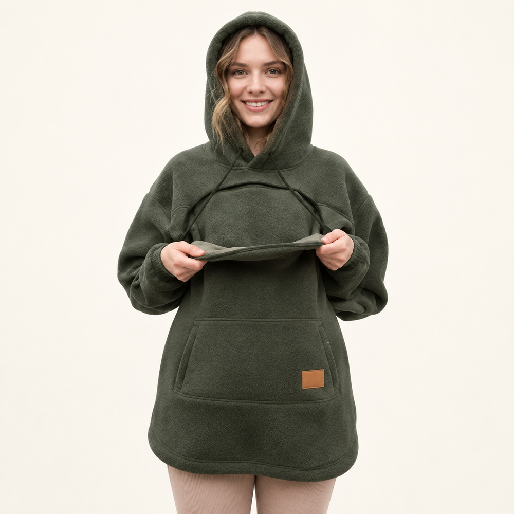 Woman demonstrating the open front pouch of an olive fleece hoodie