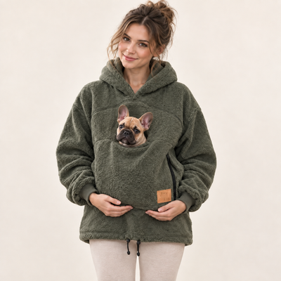 Woman wearing army green pet pouch hoodie with a French bulldog puppy