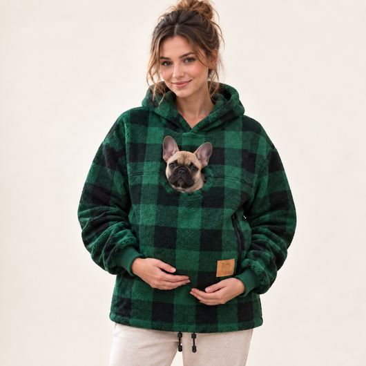 Woman wearing green pet pouch hoodie with a French bulldog puppy