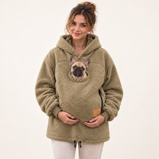 Woman wearing khaki pet pouch hoodie with a French bulldog puppy