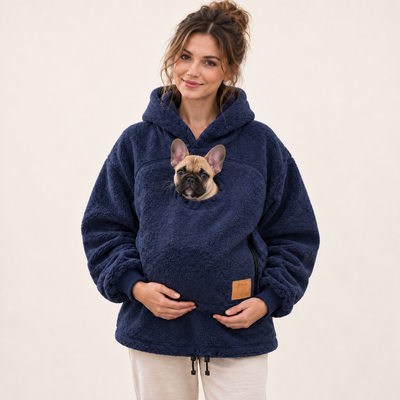 Woman wearing navy blue pet pouch hoodie with a French bulldog puppy