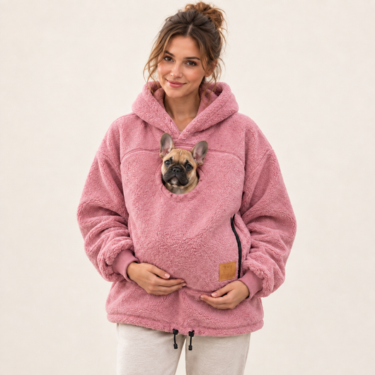 Woman wearing pink pet pouch hoodie with a French bulldog puppy
