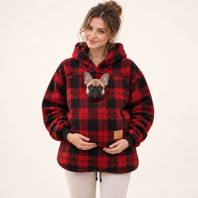 Woman wearing plaid pet pouch hoodie with a French bulldog puppy