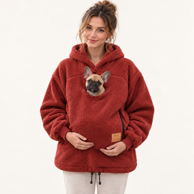 Woman wearing red pet pouch hoodie with a French bulldog puppy
