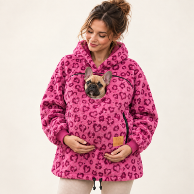 Woman wearing rose red pet pouch hoodie with a French bulldog puppy